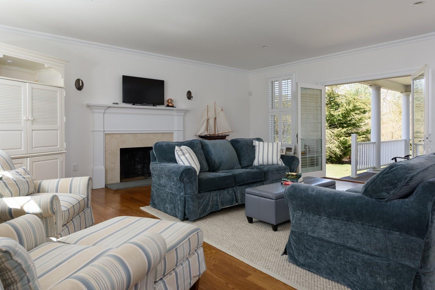 425 Scraggy Neck Road Cataumet, MA 02534 - Photo 12 of 32 a living room with furniture and a fireplace
