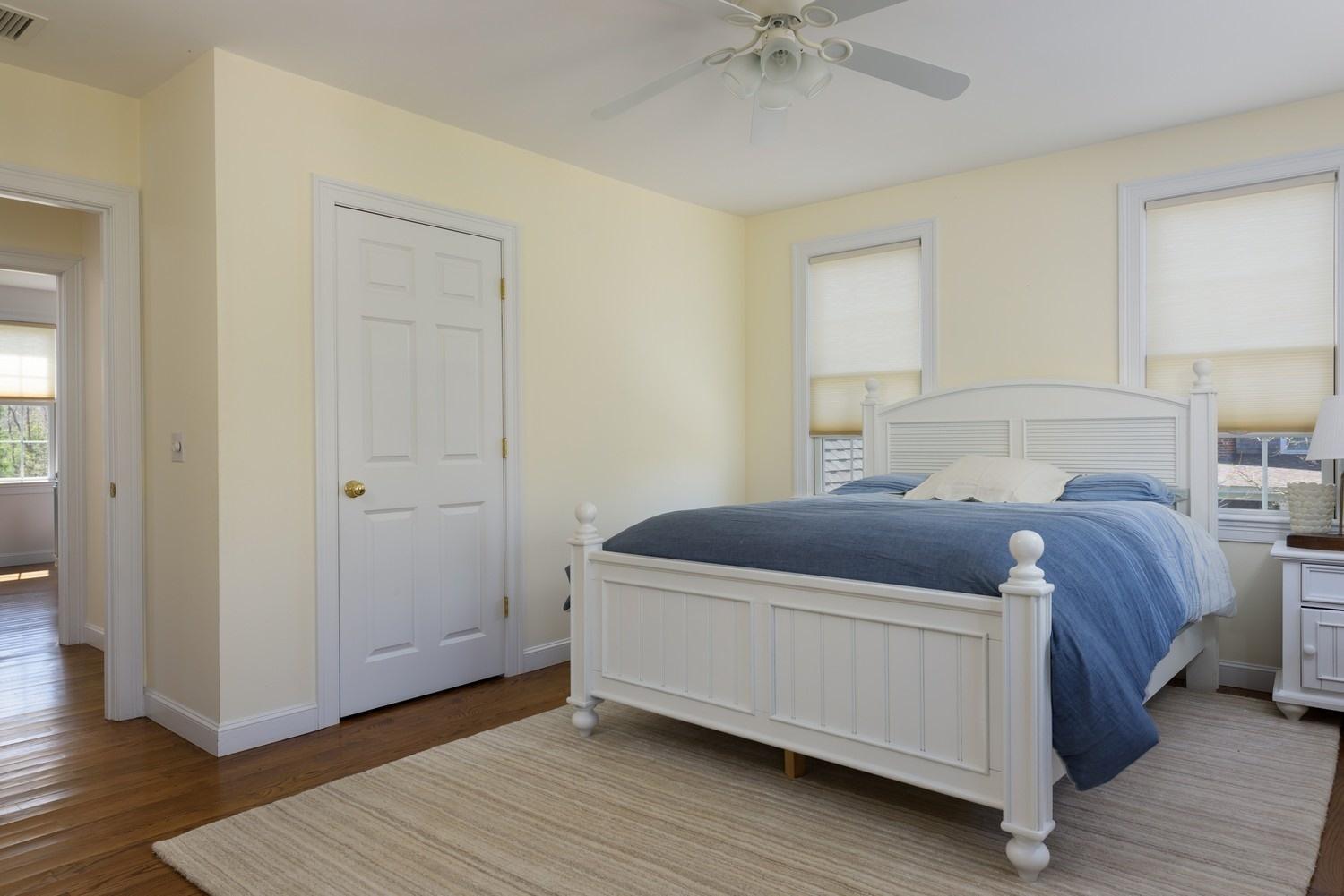 425 Scraggy Neck Road Cataumet, MA 02534 - Photo 15 of 32 a bedroom with a bed and wooden floor