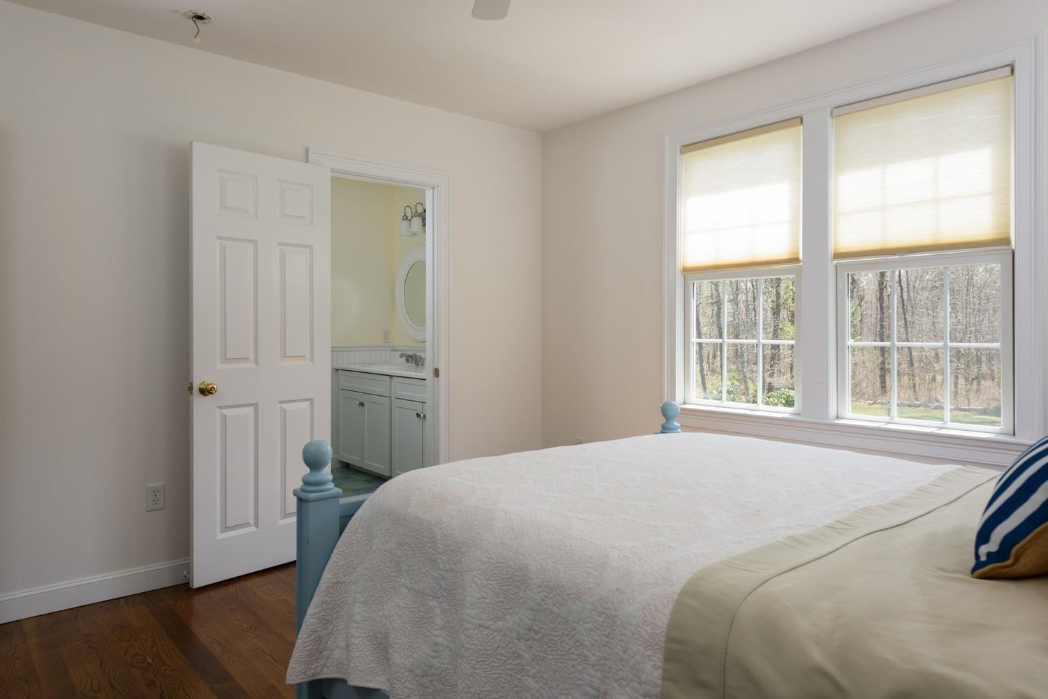 425 Scraggy Neck Road Cataumet, MA 02534 - Photo 16 of 32 a bedroom with a bed and a window