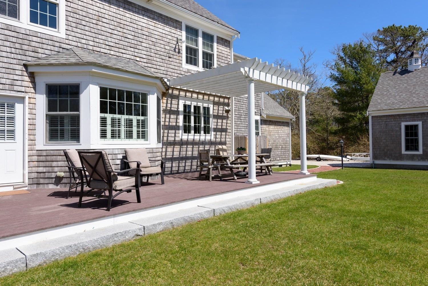 425 Scraggy Neck Road Cataumet, MA 02534 - Photo 20 of 32 a view of a house with backyard and sitting area