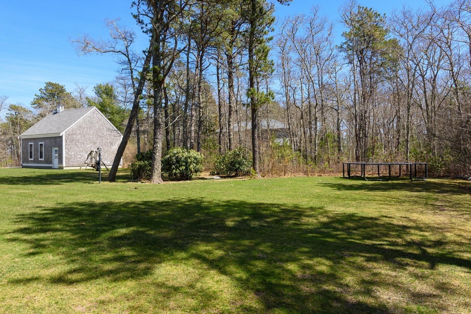 425 Scraggy Neck Road Cataumet, MA 02534 - Photo 21 of 32 a view of a backyard with large trees