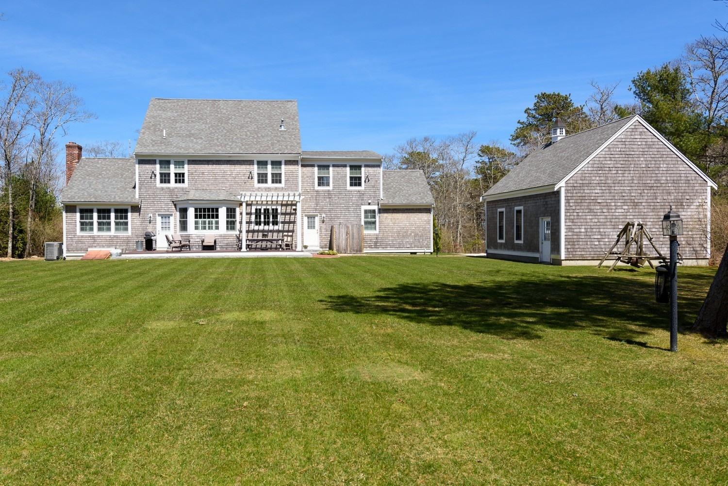425 Scraggy Neck Road Cataumet, MA 02534 - Photo 22 of 32 a front view of a house with a yard