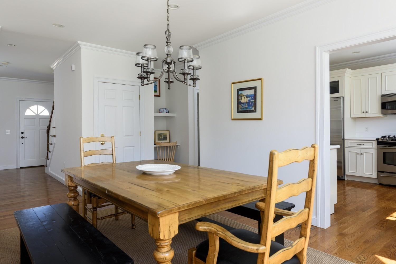 425 Scraggy Neck Road Cataumet, MA 02534 - Photo 6 of 32 a view of a dining room with furniture and wooden floor