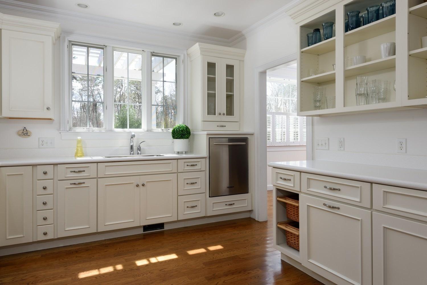 425 Scraggy Neck Road Cataumet, MA 02534 - Photo 8 of 32 a kitchen with granite countertop white cabinets and white appliances