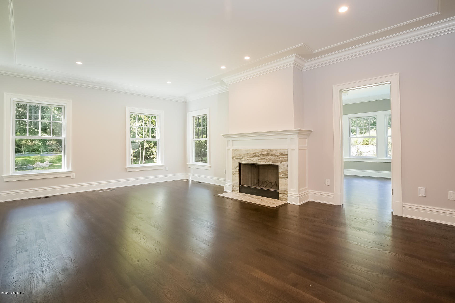 15 Cottontail Road Cos Cob, CT 06807 - Photo 3 of 13 an empty room with wooden floor fireplace and windows
