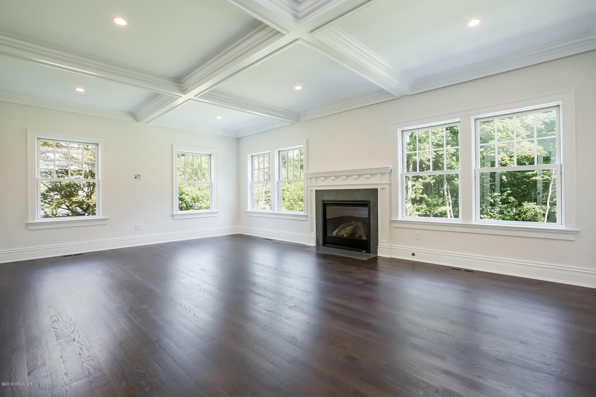 15 Cottontail Road Cos Cob, CT 06807 - Photo 7 of 13 an empty room with wooden floor fireplace and windows