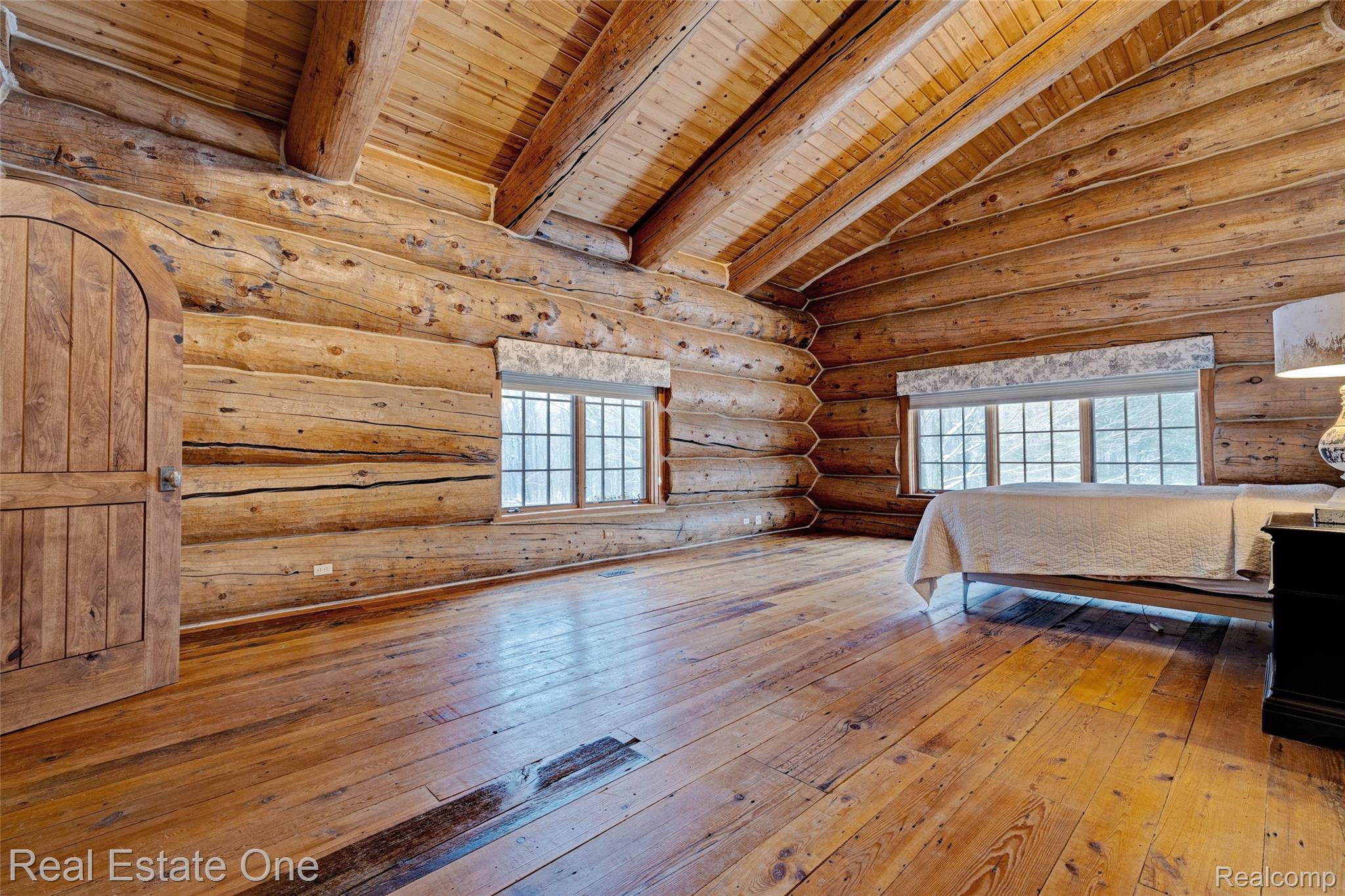 4340 Lahring Road Holly, MI 48442 - Photo 18 of 89 Bedroom featuring rustic walls, hardwood / wood-style floors, wood ceiling, and multiple windows