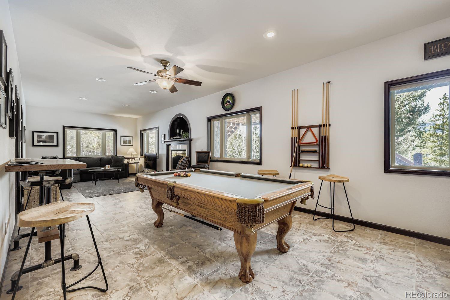 296 Desperado Road Bailey, CO 80421 - Photo 11 of 38 a living room with furniture a piano and a flat screen tv