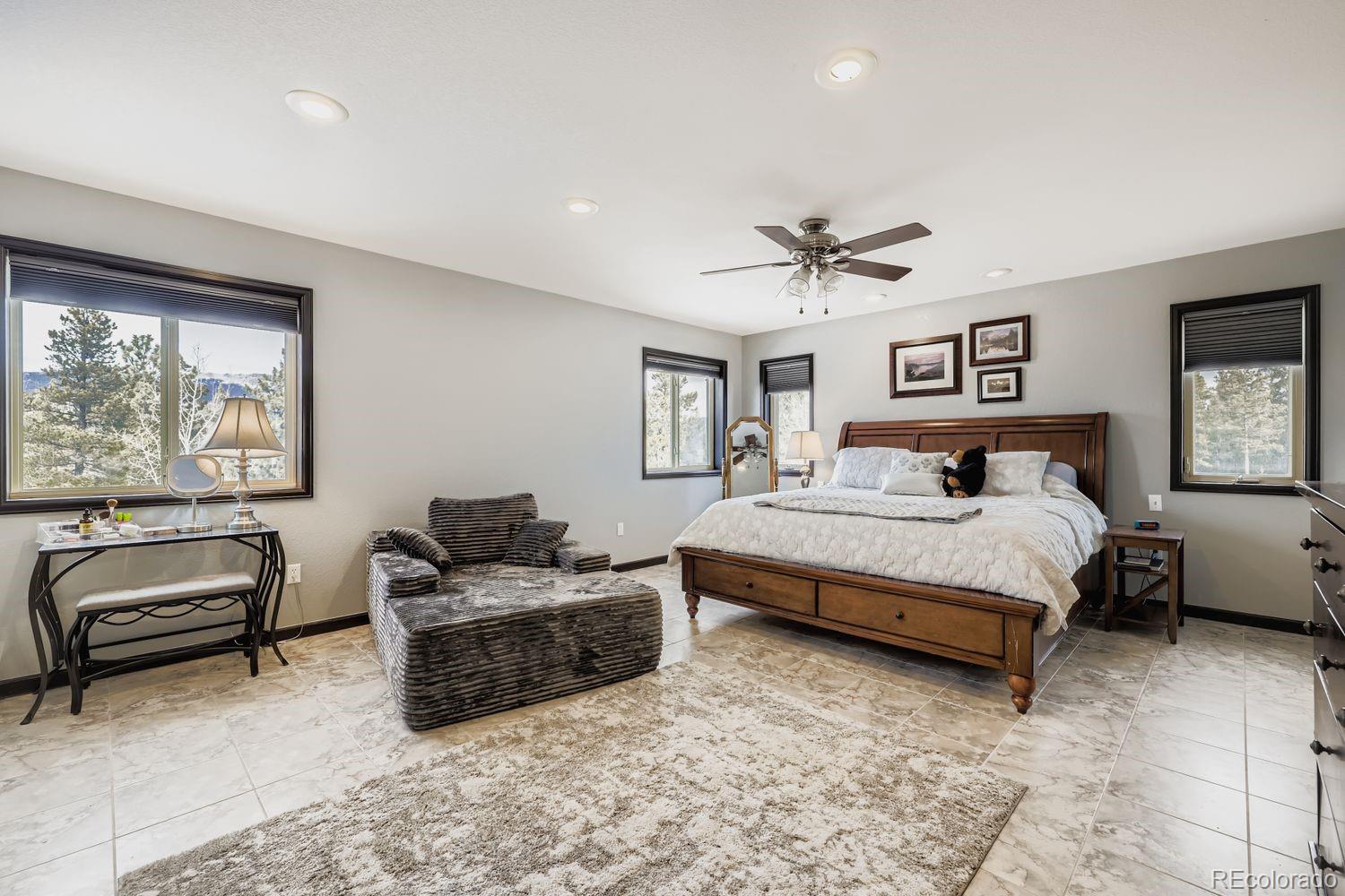 296 Desperado Road Bailey, CO 80421 - Photo 19 of 37 a bedroom with furniture and a large window