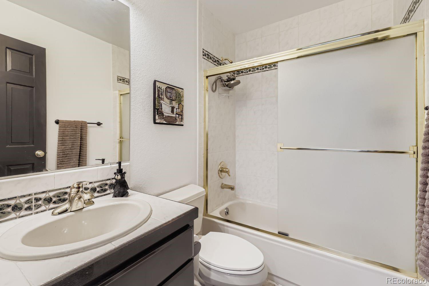 296 Desperado Road Bailey, CO 80421 - Photo 21 of 38 a bathroom with a sink toilet and shower