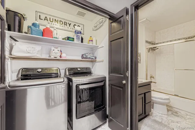 a kitchen with stainless steel appliances granite countertop a refrigerator and a stove