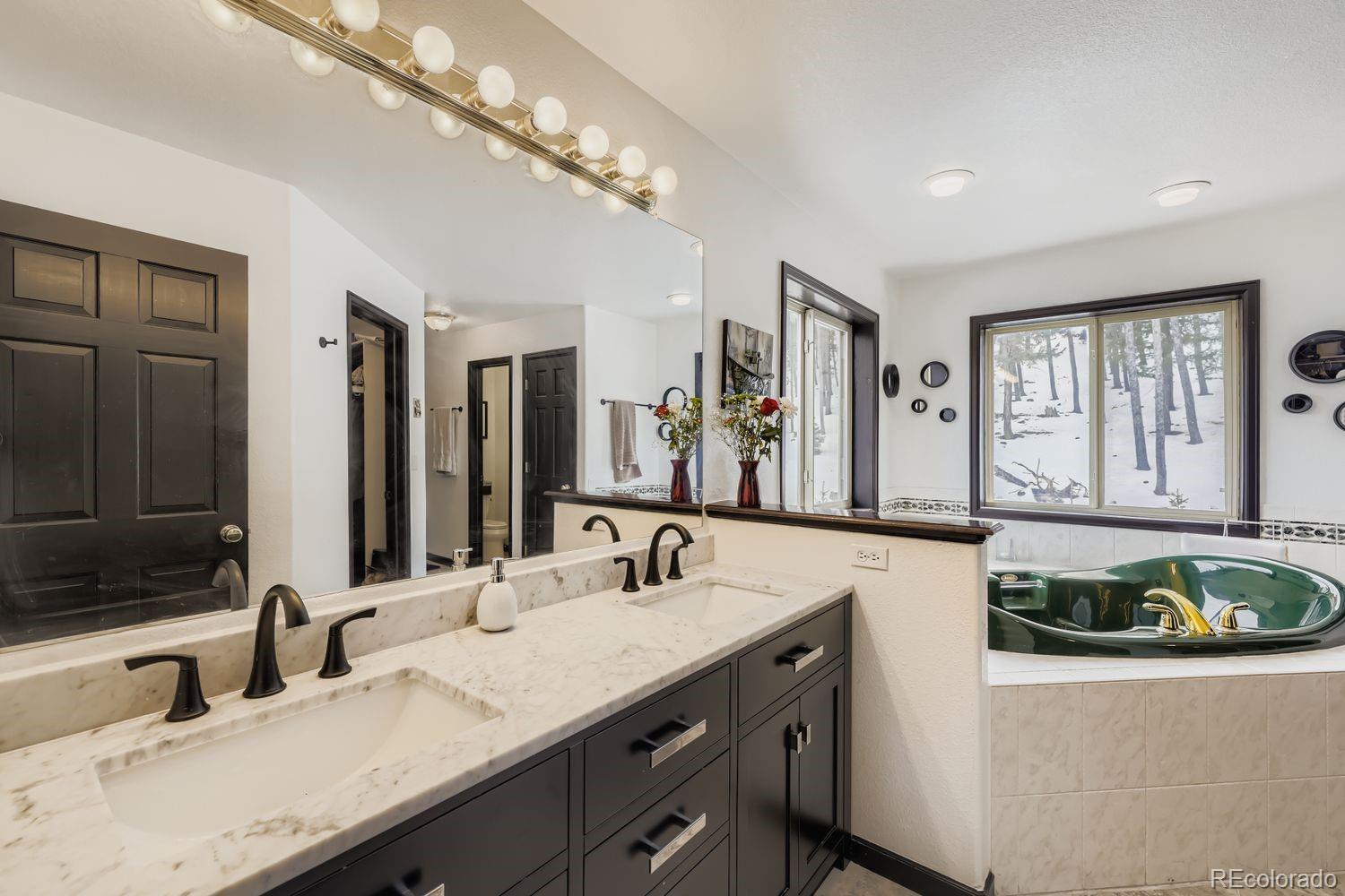 296 Desperado Road Bailey, CO 80421 - Photo 24 of 38 a bathroom with a sink and a mirror