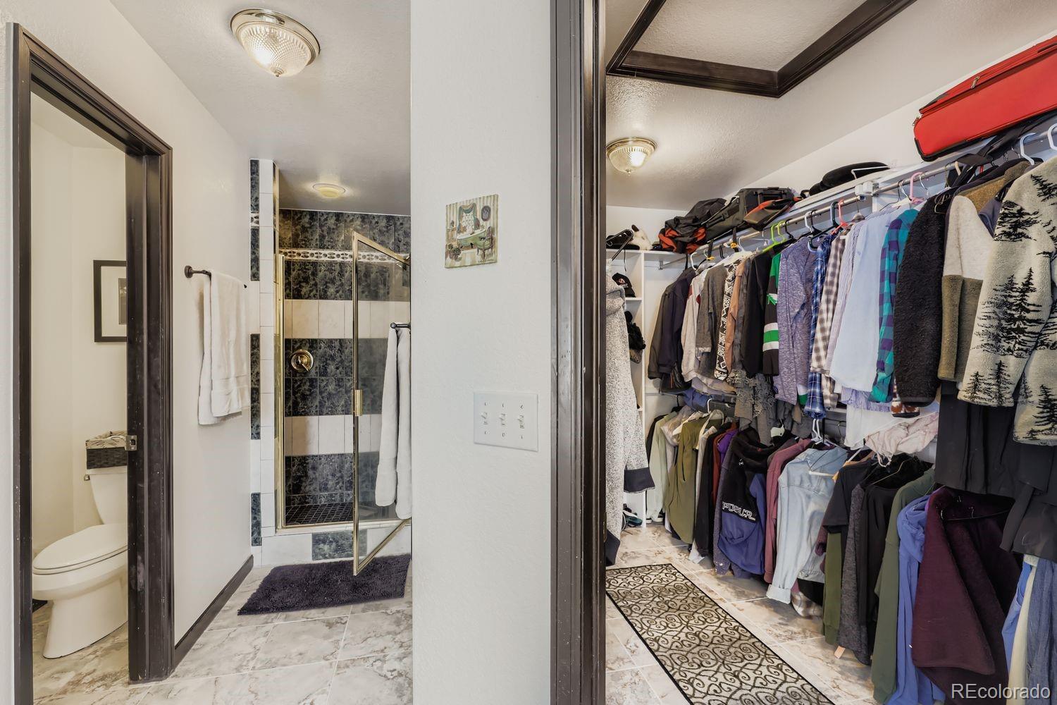 296 Desperado Road Bailey, CO 80421 - Photo 26 of 38 a view of walk in closet with clothes and shoes
