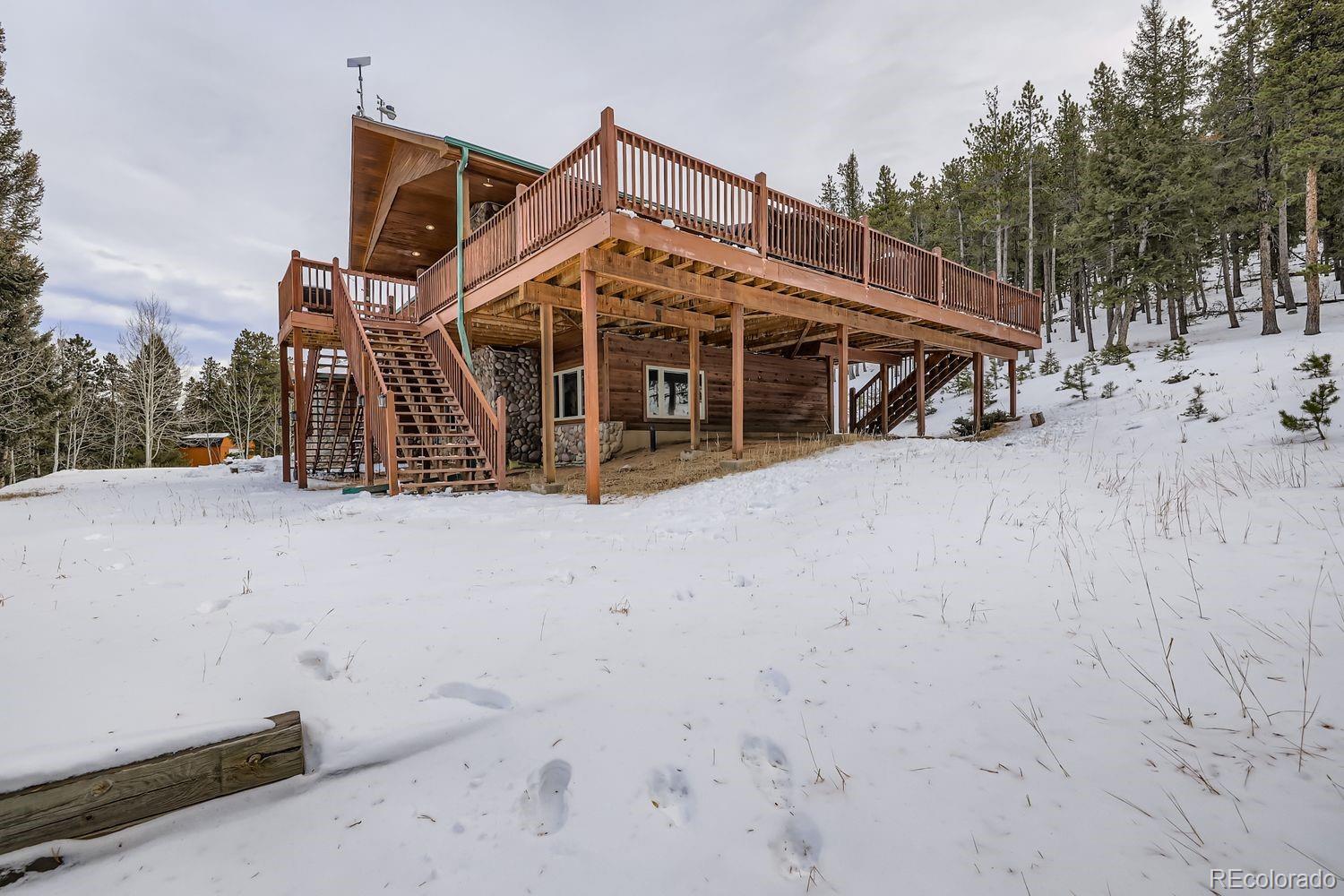 296 Desperado Road Bailey, CO 80421 - Photo 3 of 38 a view of a house with a wooden deck