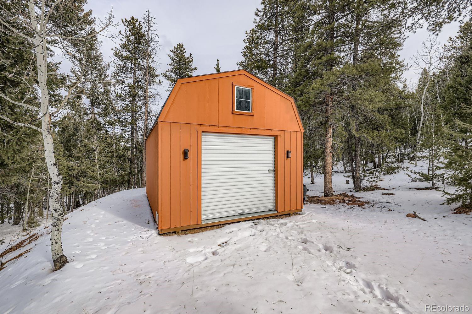 296 Desperado Road Bailey, CO 80421 - Photo 34 of 37 a view of a house with a trees