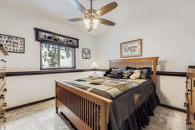 a bedroom with a bed a window and a dresser