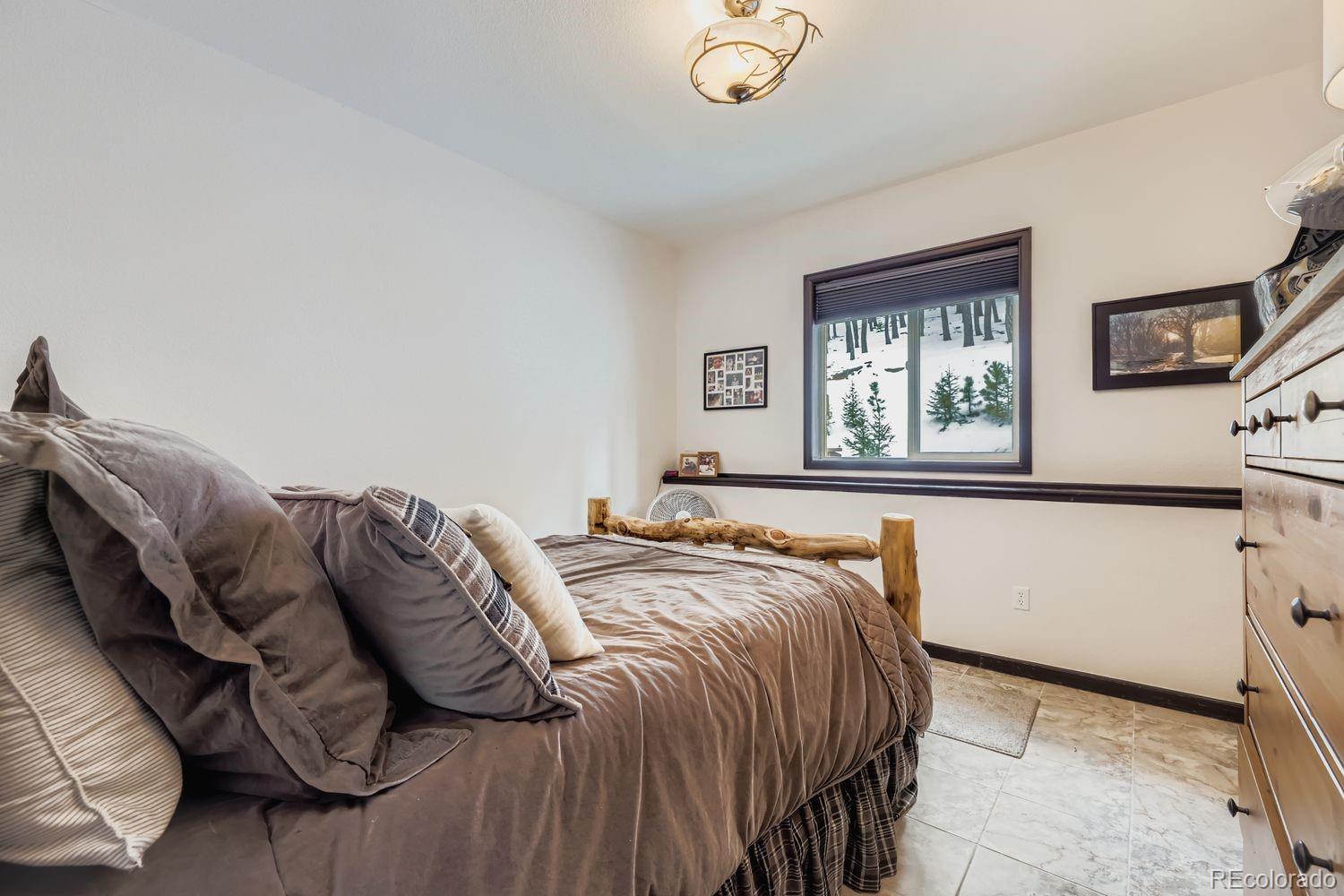 296 Desperado Road Bailey, CO 80421 - Photo 8 of 38 a bedroom with a bed and window