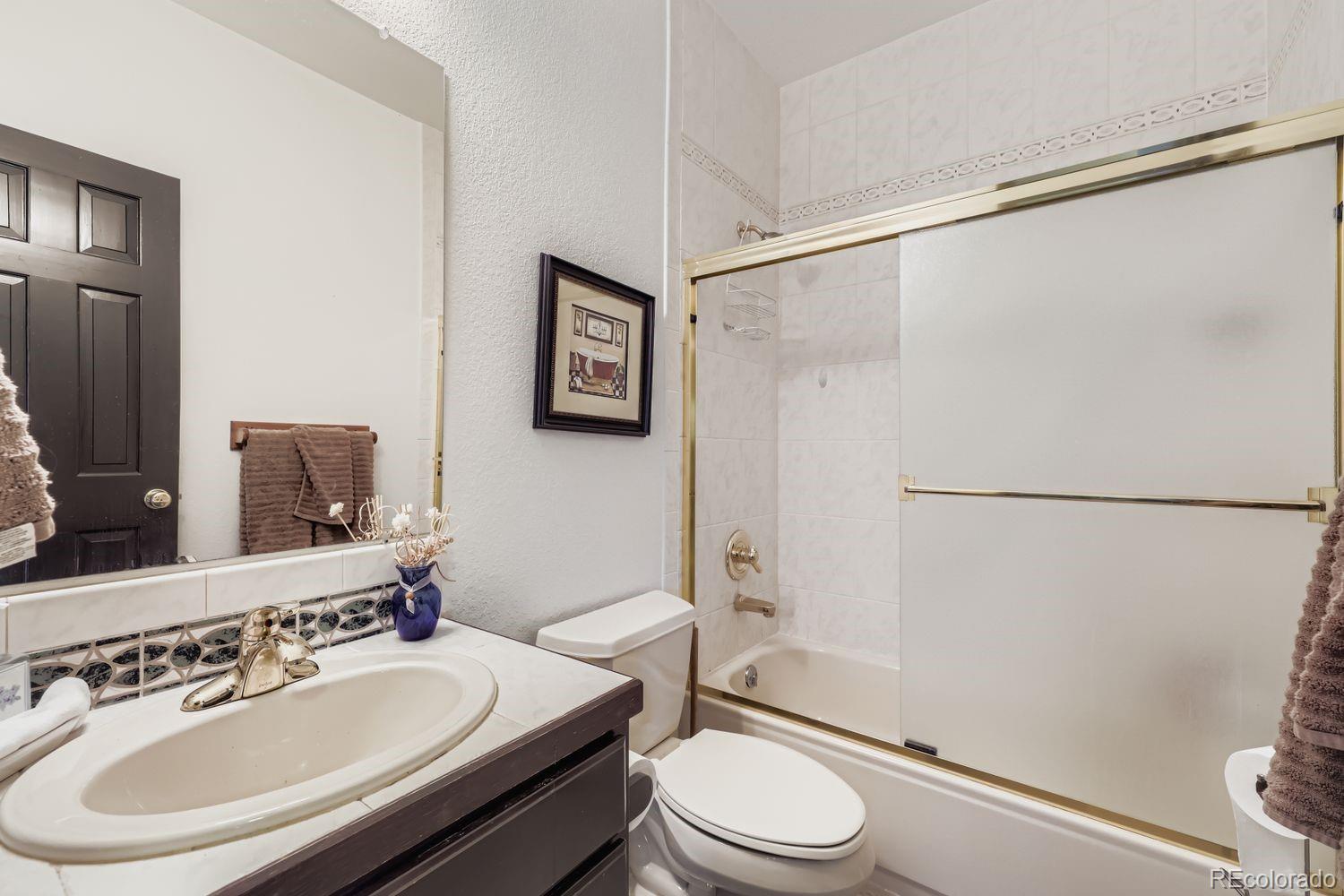 296 Desperado Road Bailey, CO 80421 - Photo 9 of 38 a bathroom with a sink toilet and shower