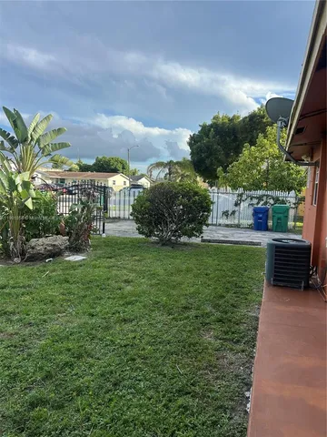 a view of a garden with a house in the background
