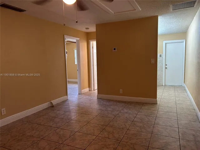 a view of an empty room with a bathroom