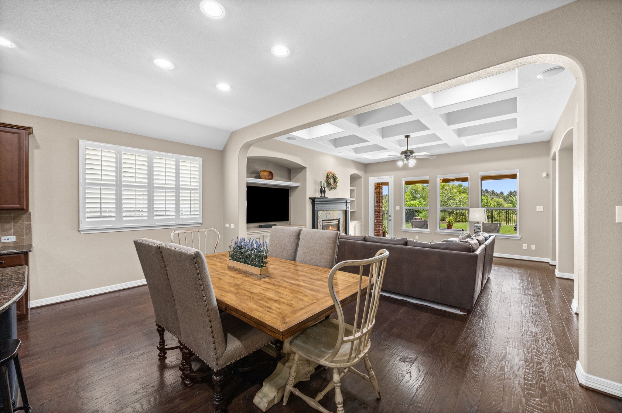 27642 Linden Ridge Lane Fulshear, TX 77441 - Photo 10 of 42 The Dining Area is perfect for everyday meals, offering a warm and inviting space filled with natural light. Shuttered windows provide both privacy and style while allowing plenty of sunshine to filter in, complemented by elegant ceiling lighting that enhances the space day and night.
