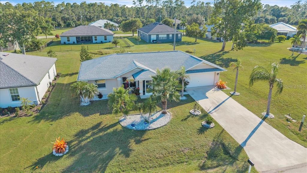 an aerial view of a house with a yard