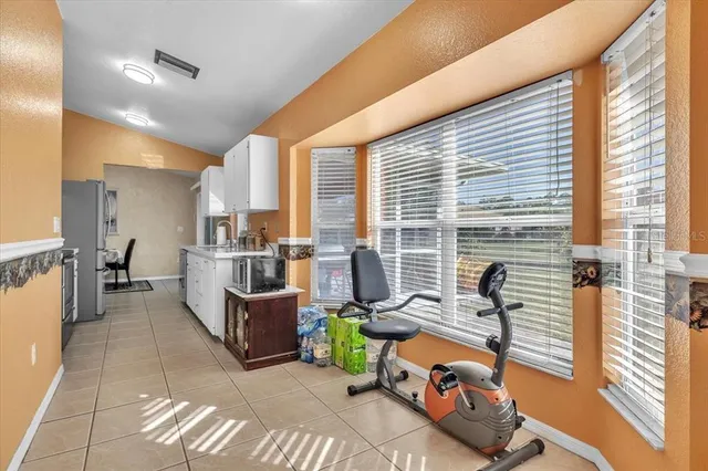 a living room with furniture and large windows