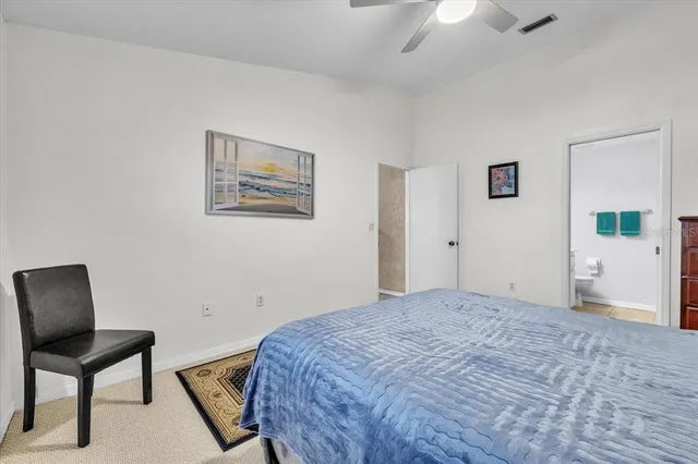 a bedroom with a bed and a chair