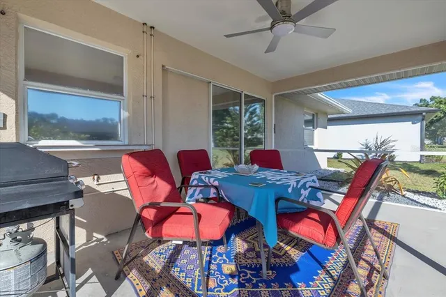 a living room with furniture a rug and a chandelier