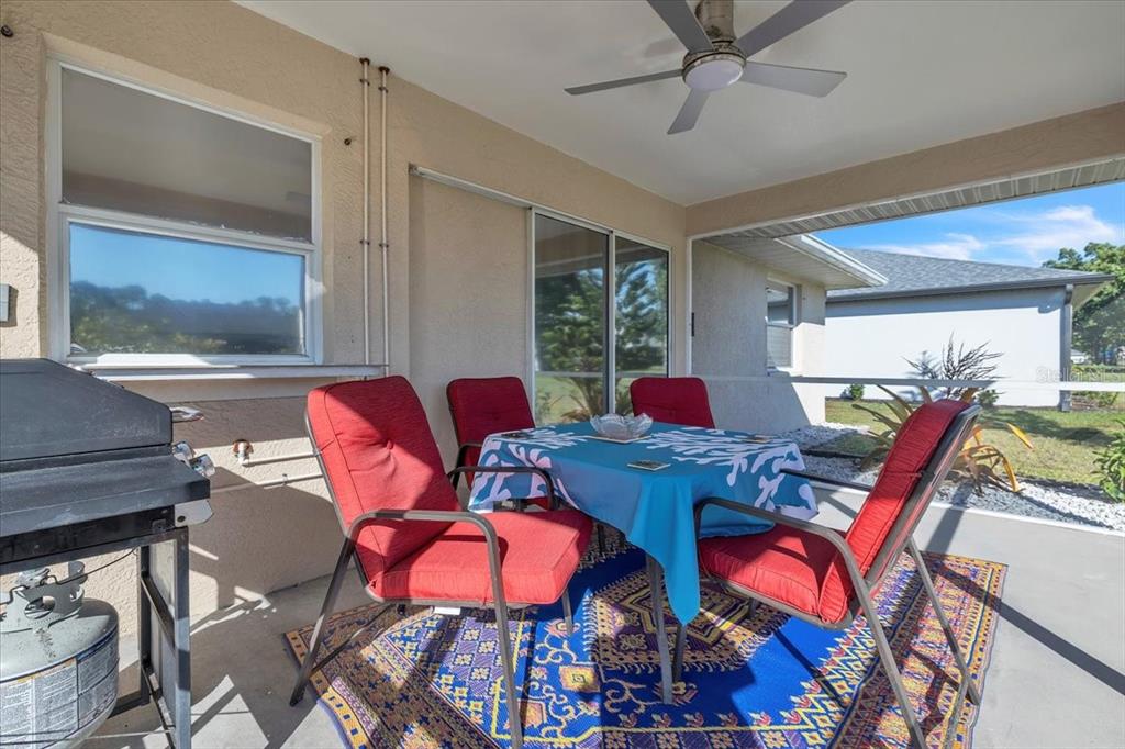 25313 Durango Court Punta Gorda, FL 33955 - Photo 24 of 34 a living room with furniture a rug and a chandelier