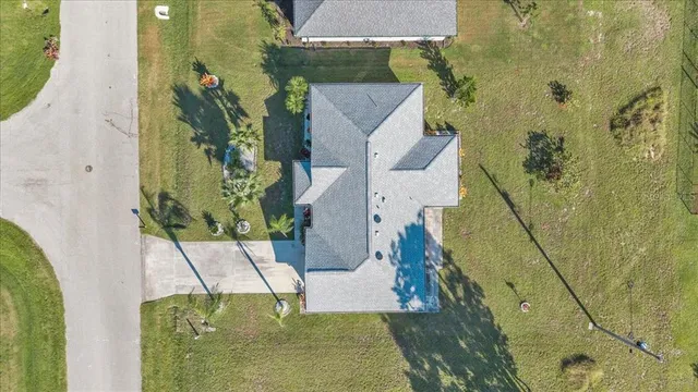 an aerial view of a house with a yard