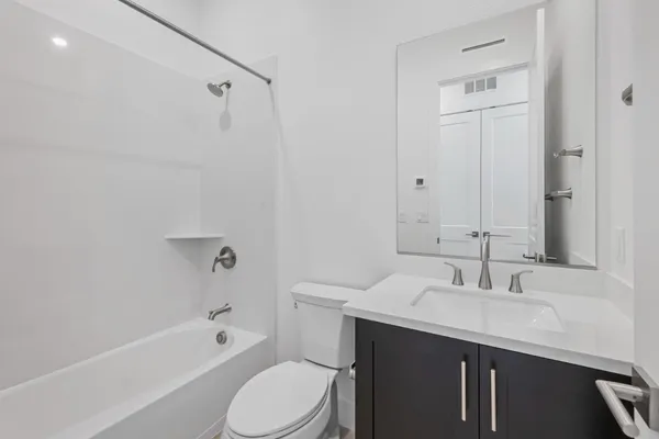 a bathroom with a double vanity sink mirror and shower