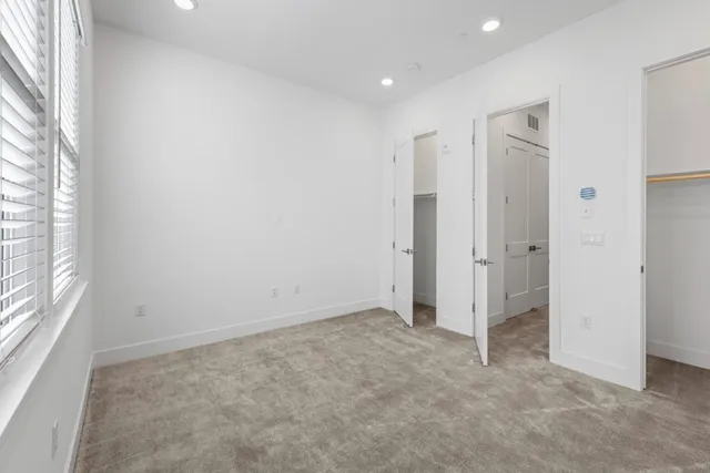 a view of an empty room and a window