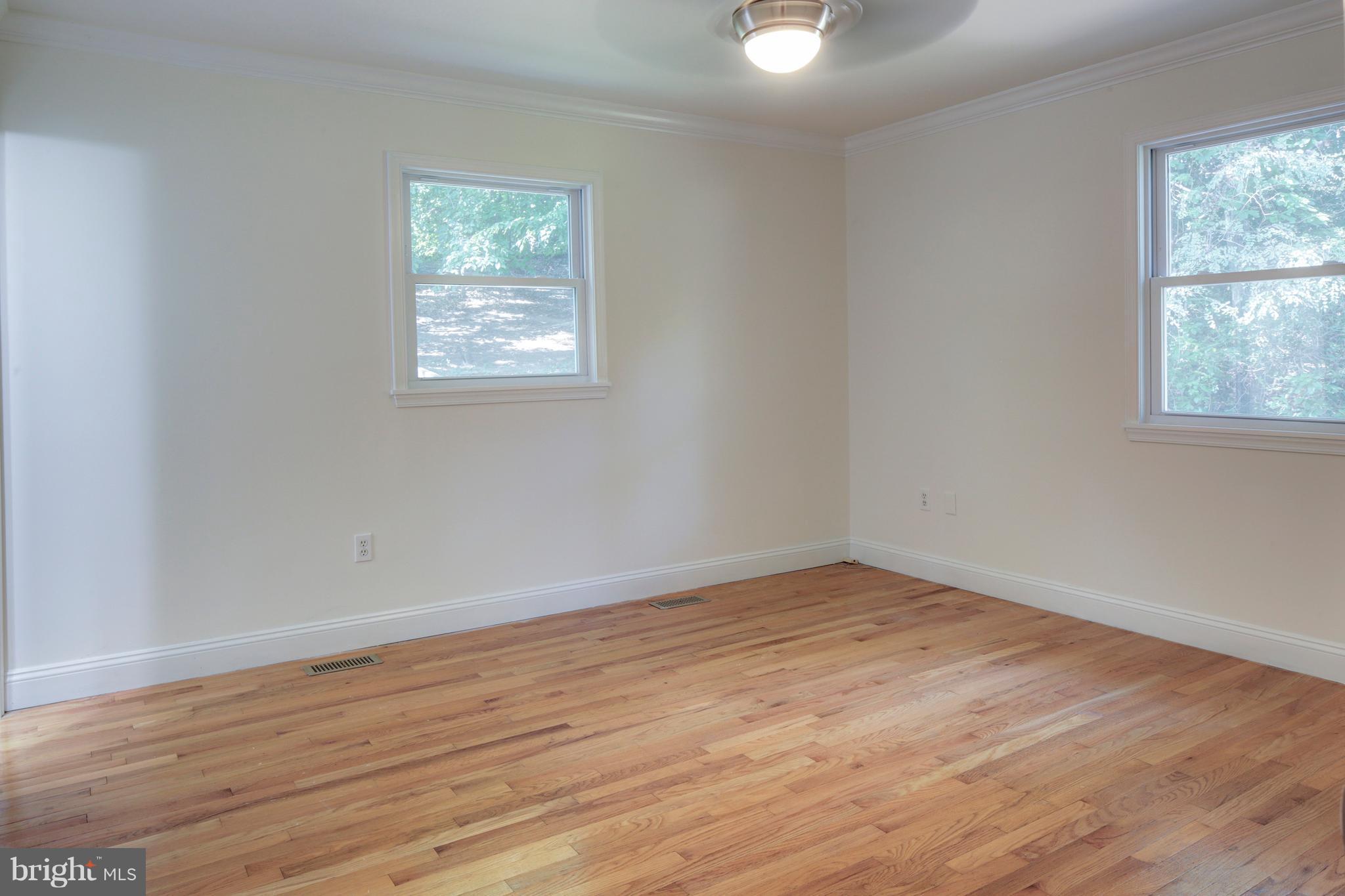 502 Hoot Owl Road Riva, MD 21140 - Photo 13 of 30 an empty room with wooden floor and windows