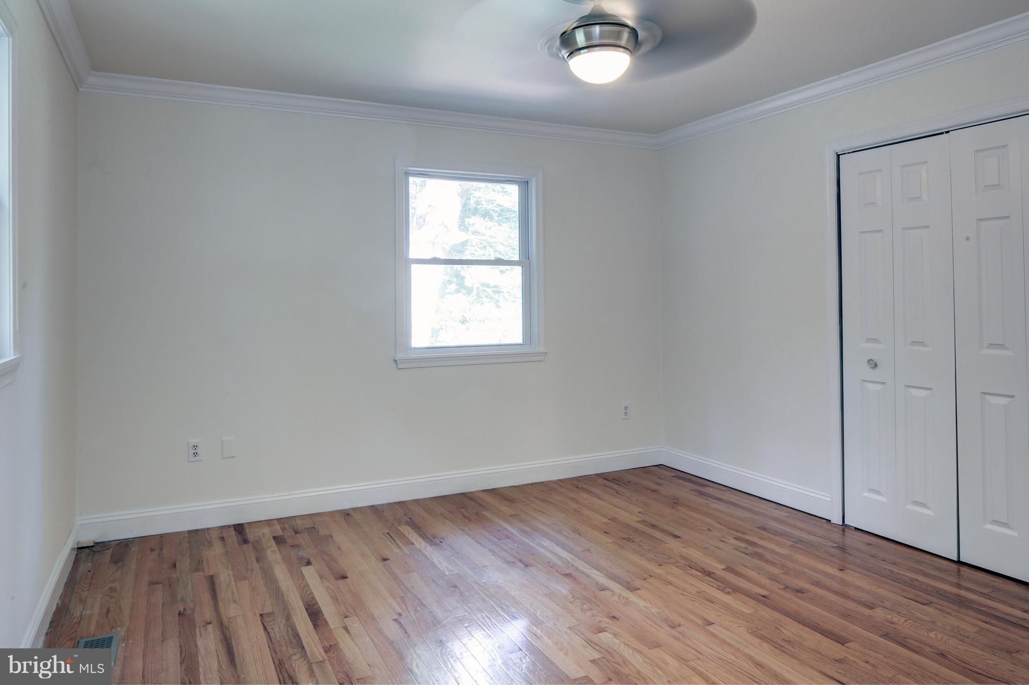 502 Hoot Owl Road Riva, MD 21140 - Photo 15 of 30 an empty room with wooden floor and windows