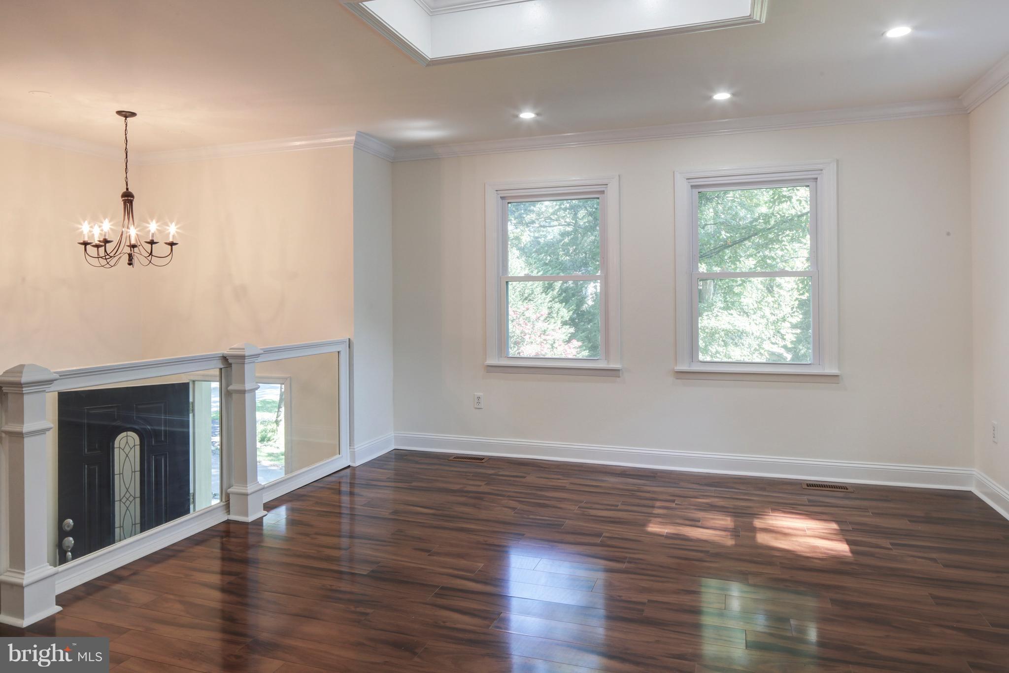 502 Hoot Owl Road Riva, MD 21140 - Photo 5 of 30 a view of an empty room with wooden floor fireplace and a window