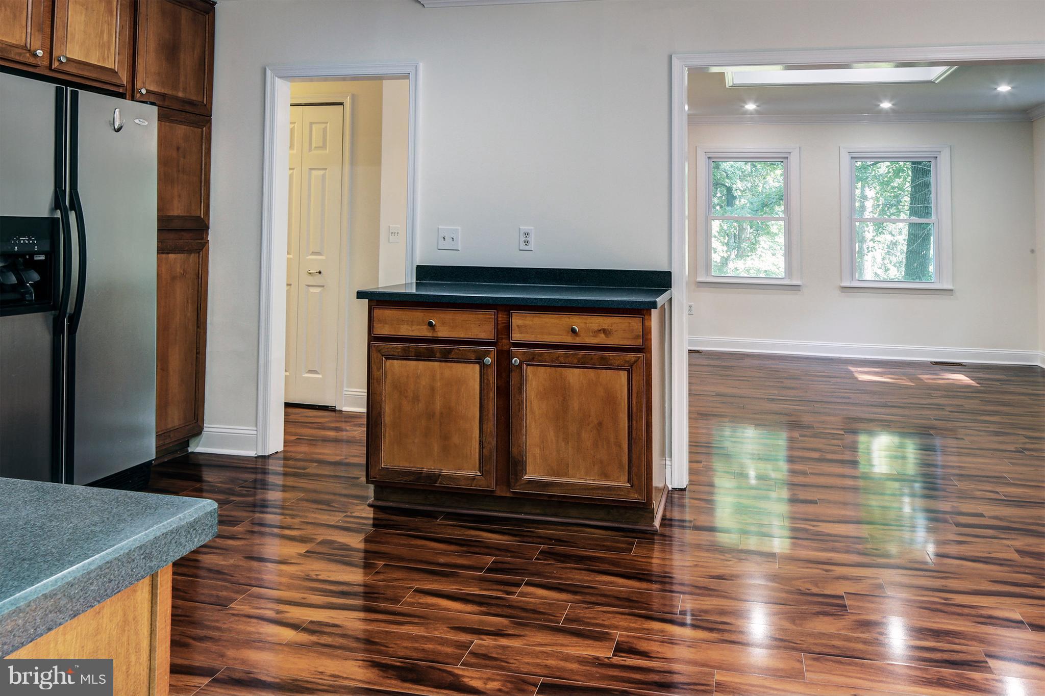 502 Hoot Owl Road Riva, MD 21140 - Photo 8 of 30 a view of a hallway with wooden floor and staircase