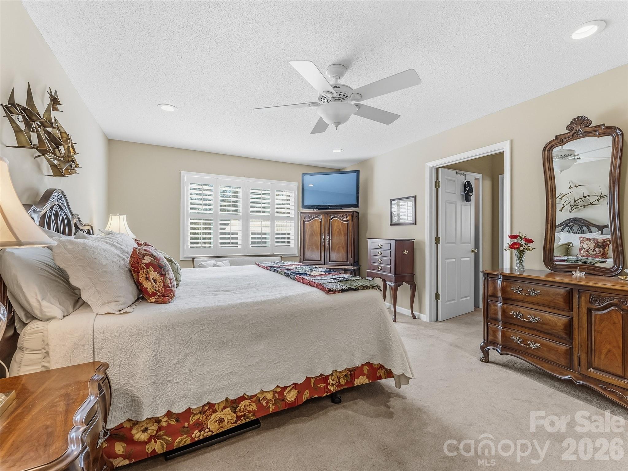 1340 Macedonia Road Saluda, NC 28773 - Photo 22 of 45 a bedroom with a large bed and a chandelier