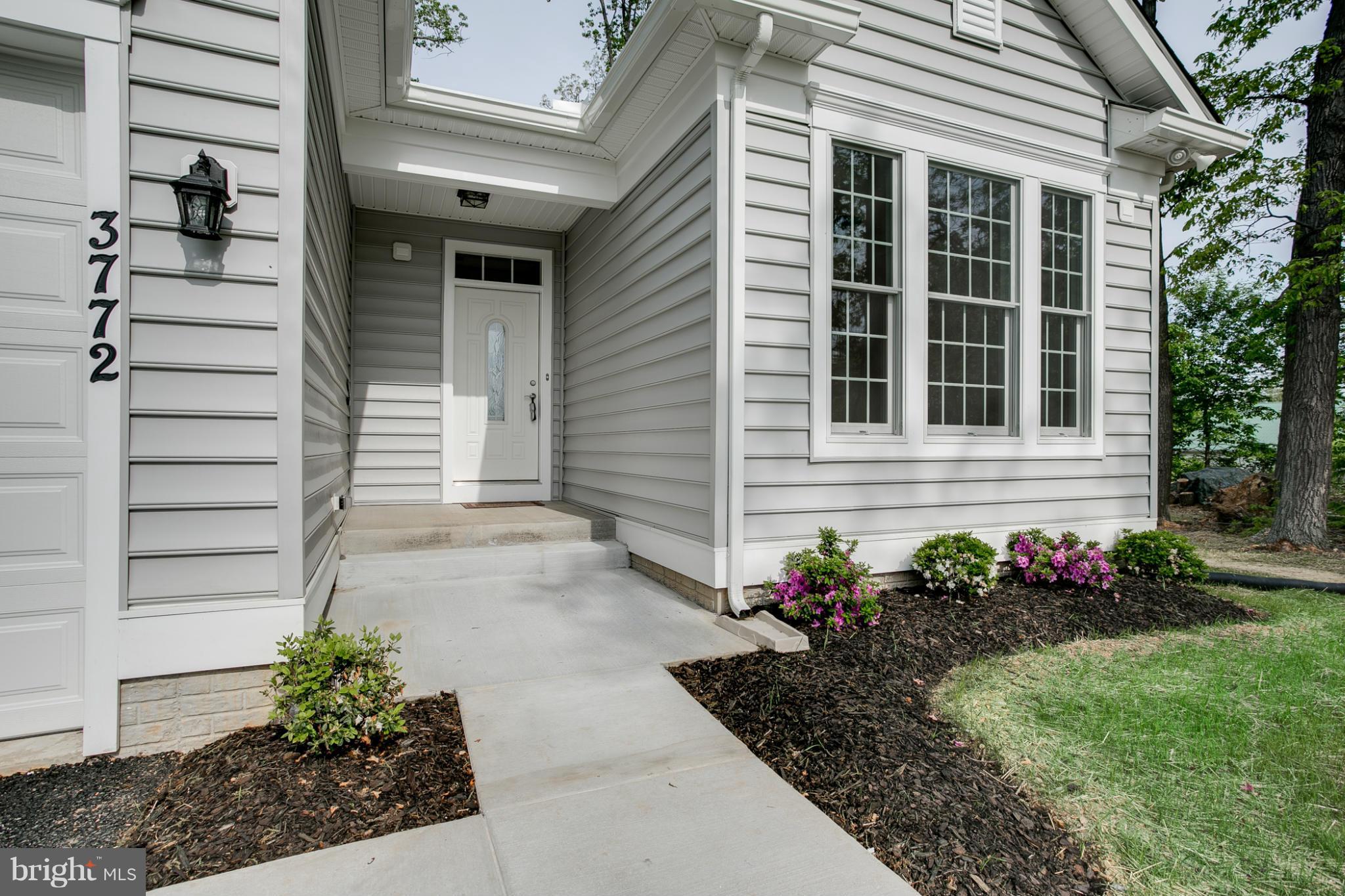 3772 Hooper Road New Windsor, MD 21776 - Photo 2 of 30 a front view of a house with a garden