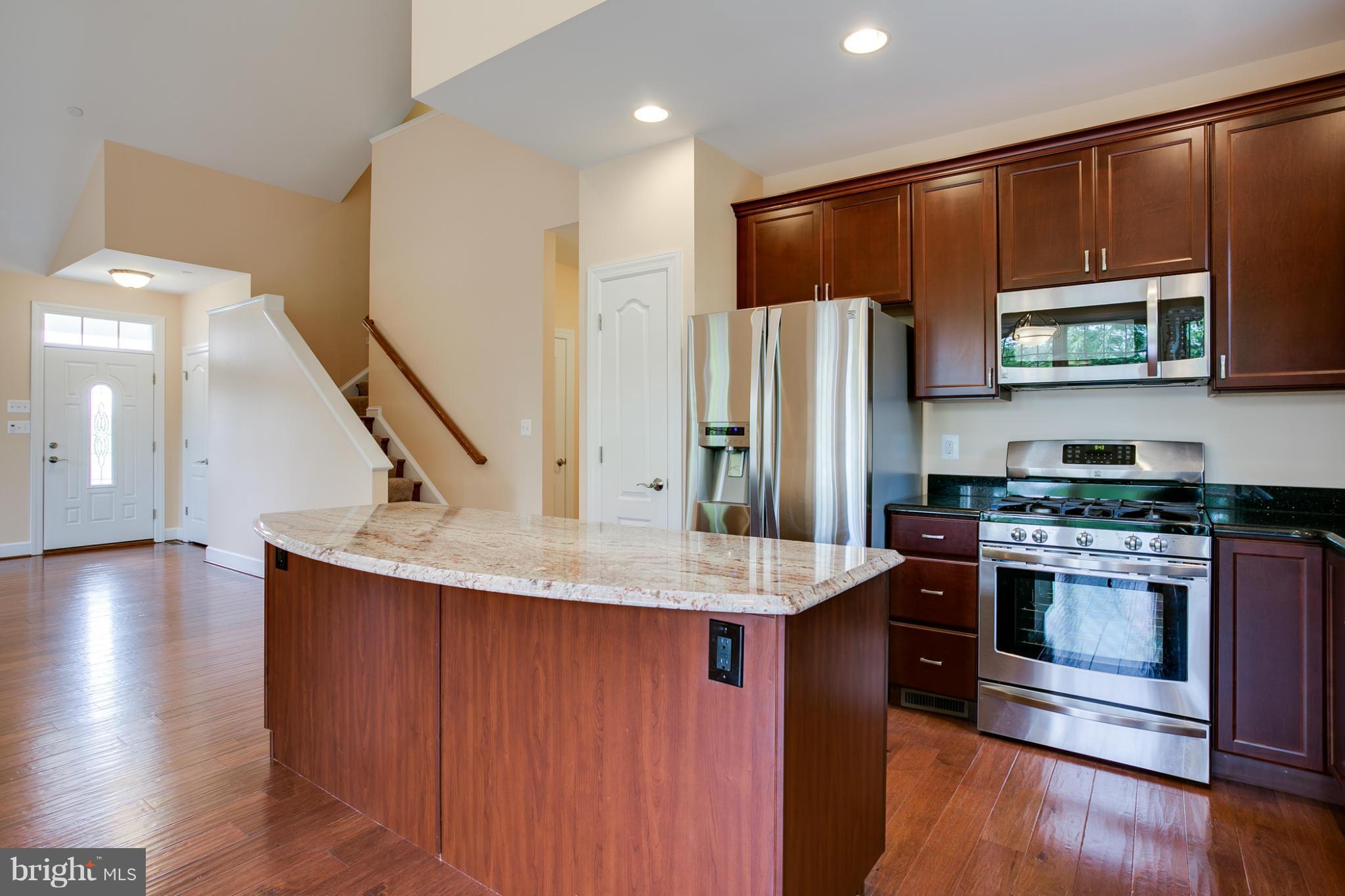 3772 Hooper Road New Windsor, MD 21776 - Photo 11 of 30 a kitchen with stainless steel appliances a microwave a stove and refrigerator