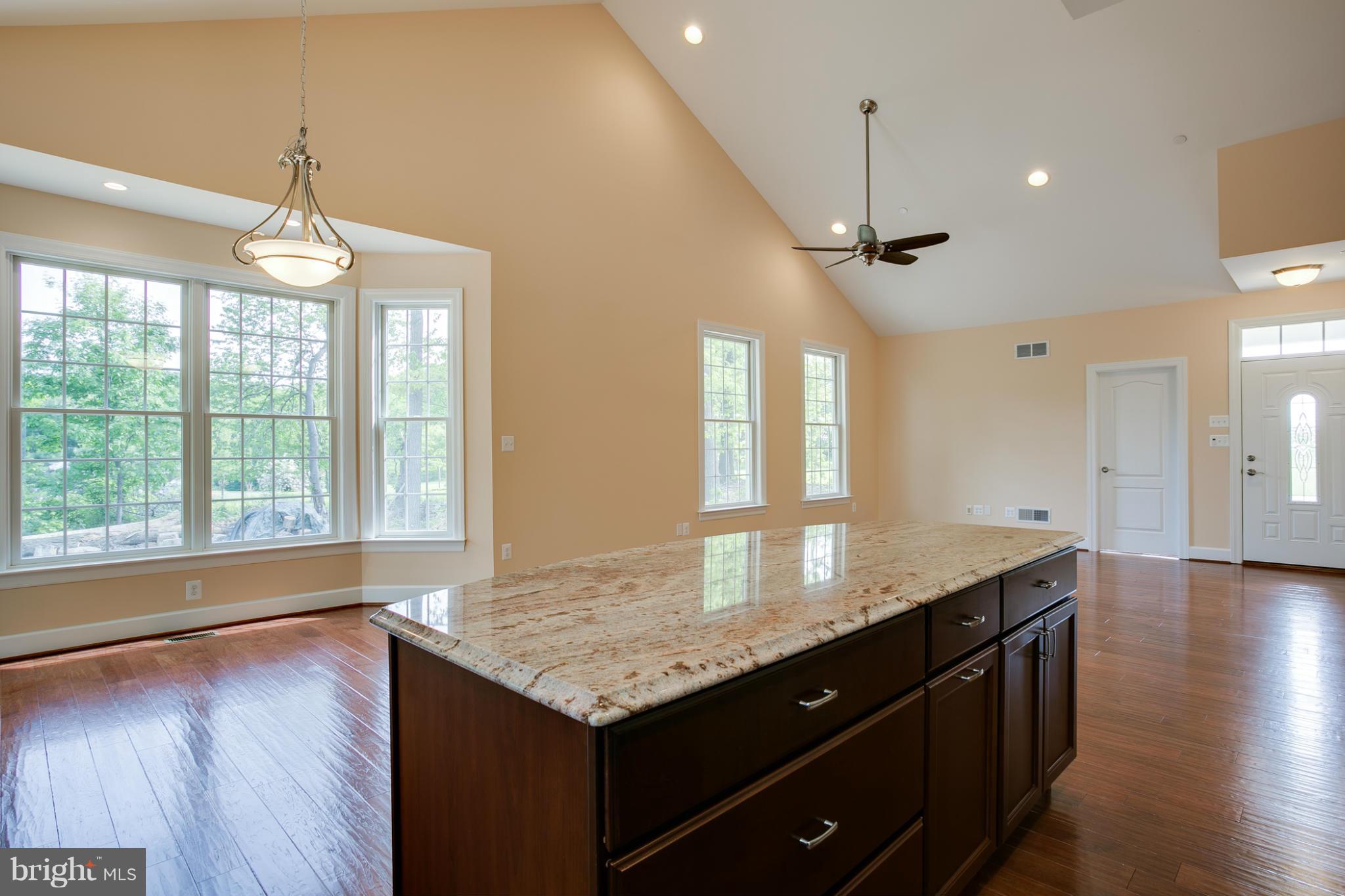 3772 Hooper Road New Windsor, MD 21776 - Photo 12 of 30 a kitchen with granite countertop a sink window and wooden floor