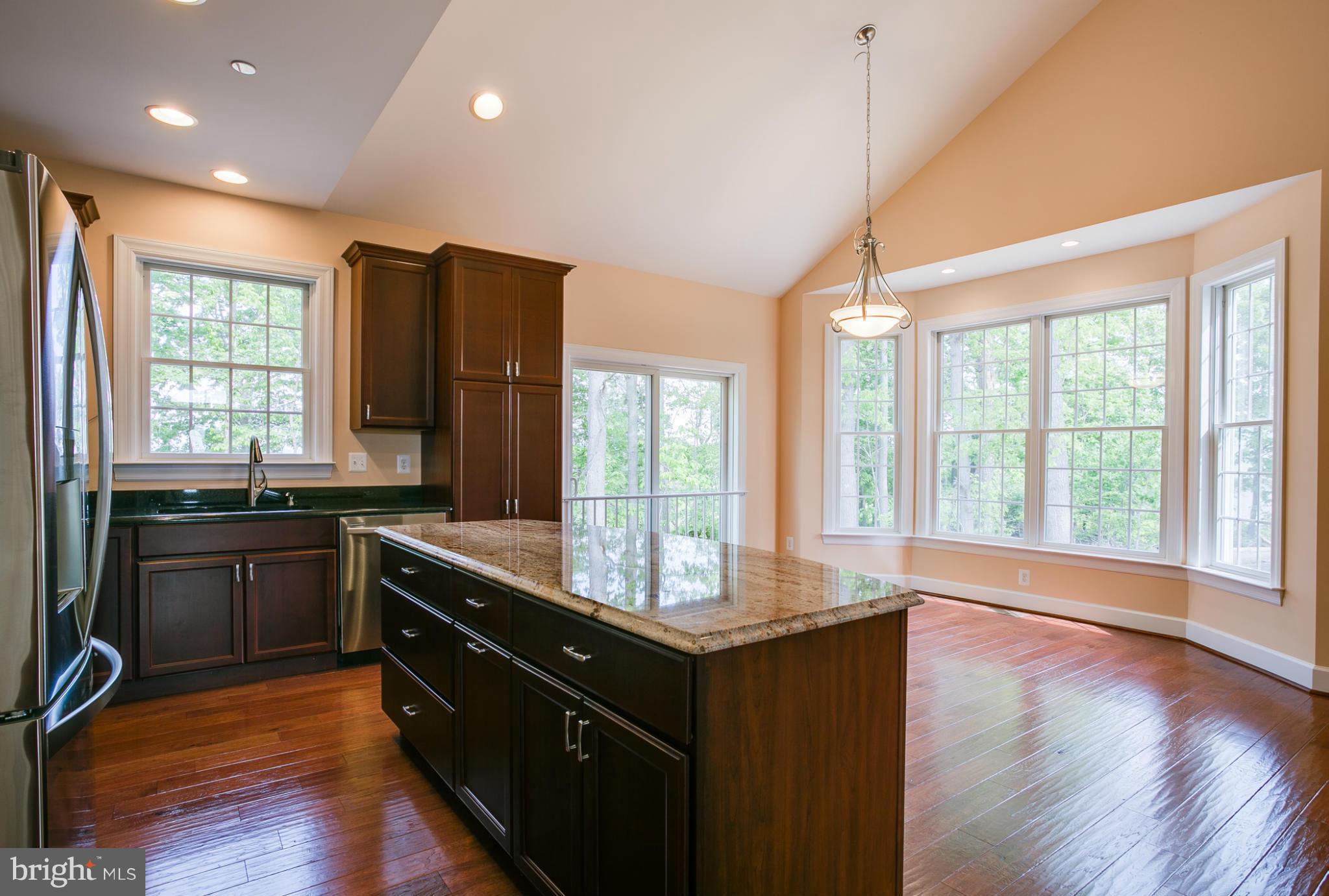 3772 Hooper Road New Windsor, MD 21776 - Photo 13 of 30 a kitchen with granite countertop a stove a sink and wooden floors
