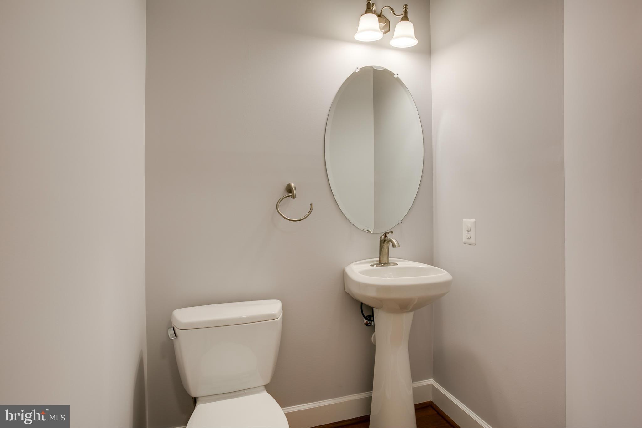 3772 Hooper Road New Windsor, MD 21776 - Photo 24 of 30 a bathroom with a toilet a sink and a mirror