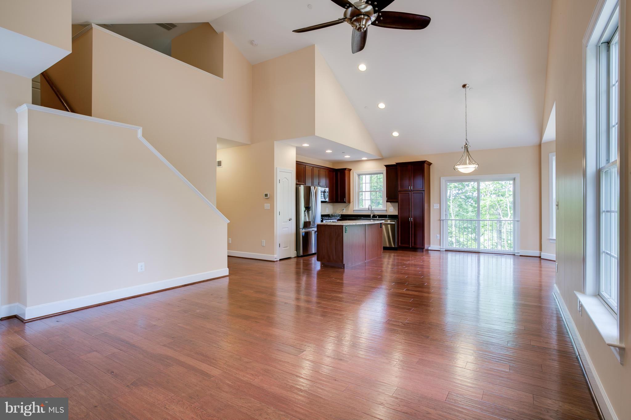 3772 Hooper Road New Windsor, MD 21776 - Photo 7 of 30 a view of a kitchen with a refrigerator a ceiling fan and wooden floor