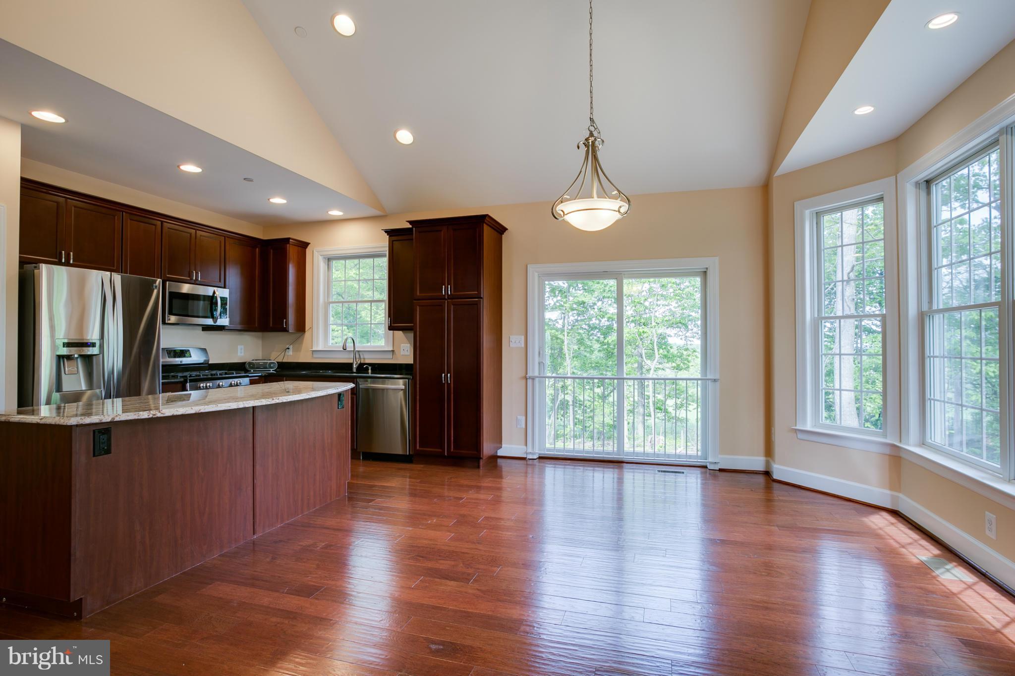 3772 Hooper Road New Windsor, MD 21776 - Photo 9 of 30 a open kitchen with stainless steel appliances granite countertop a refrigerator a sink dishwasher a stove and a refrigerator with wooden floor