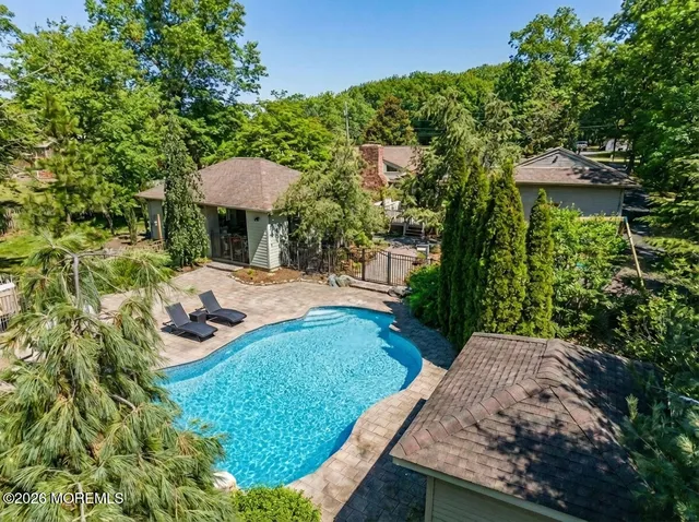 a view of a backyard with table and chairs under an umbrella