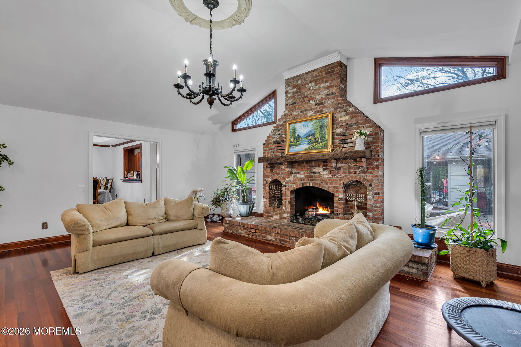 1731 Silverton Road Toms River, NJ 08753 - Photo 11 of 46 a living room with furniture a chandelier and a fireplace