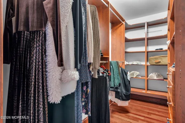 a view of a dining room with furniture a chandelier and wooden floor