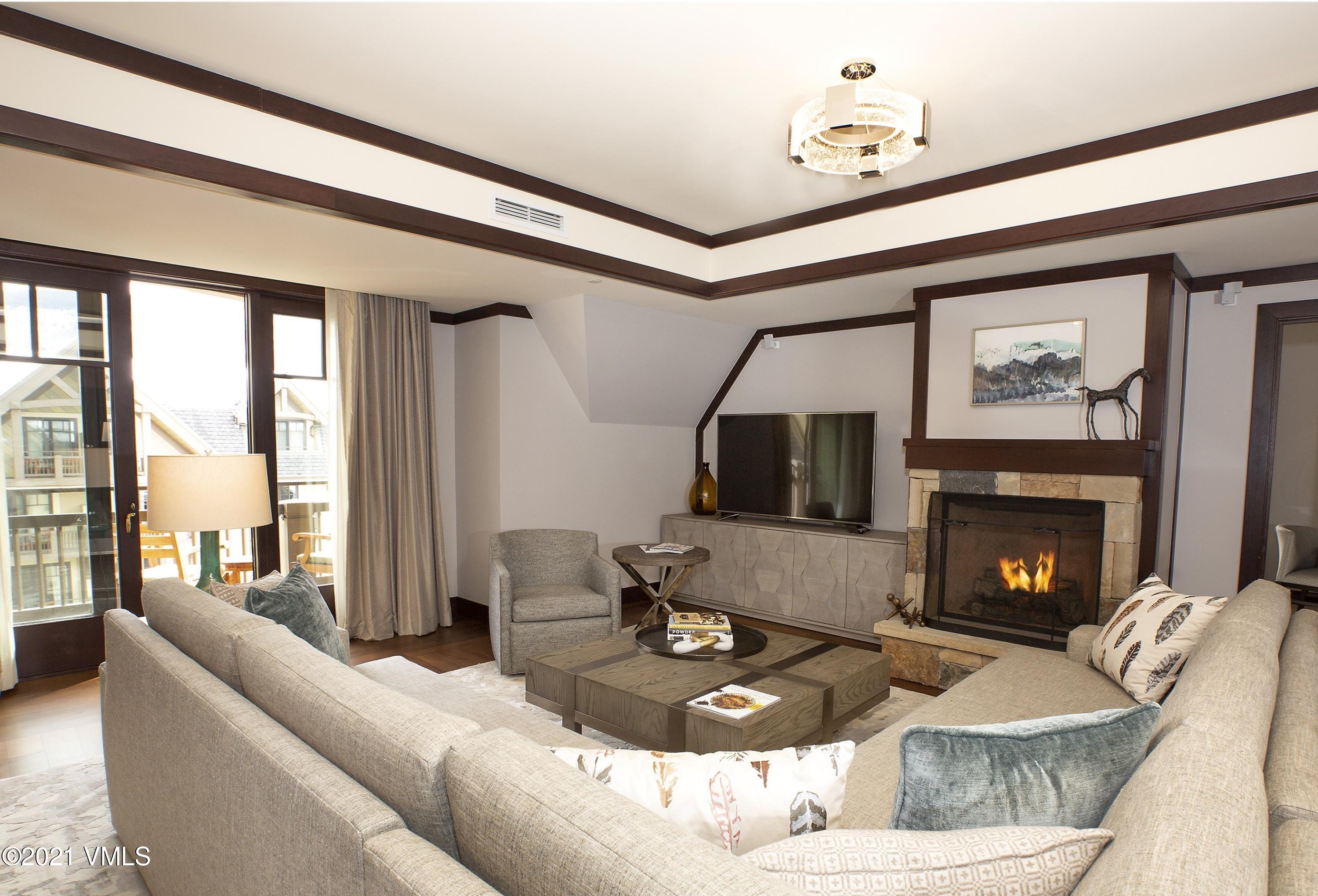1 Vail Road, Unit 6102D Vail, CO 81657 - Photo 3 of 9 a living room with furniture a flat screen tv and a fireplace