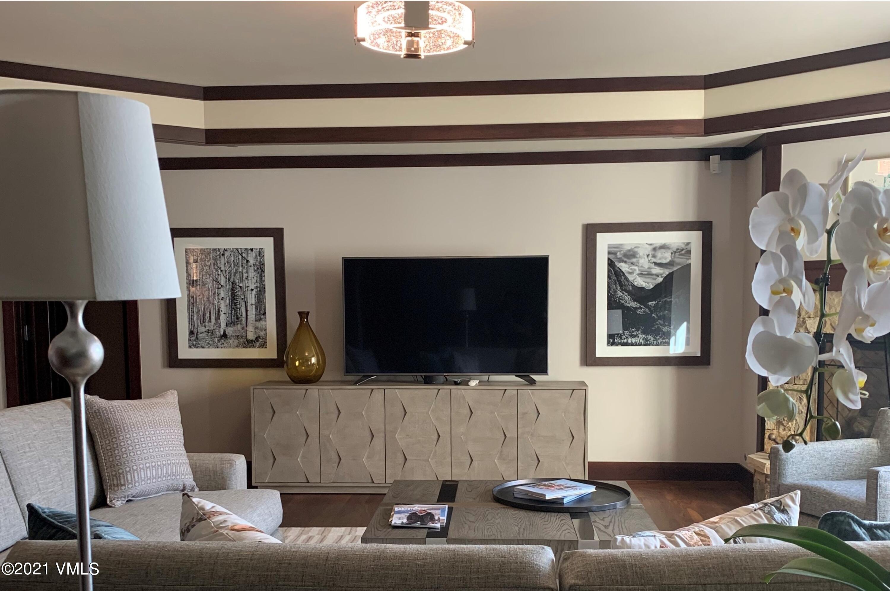 1 Vail Road, Unit 6102D Vail, CO 81657 - Photo 4 of 9 a living room with furniture and a flat screen tv
